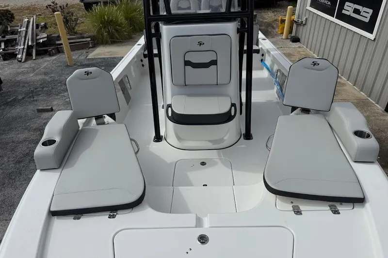 Slide: The Image of 2026 Sea Pro 230 Bay boat interior with cushioned seating and cup holders. - 24
