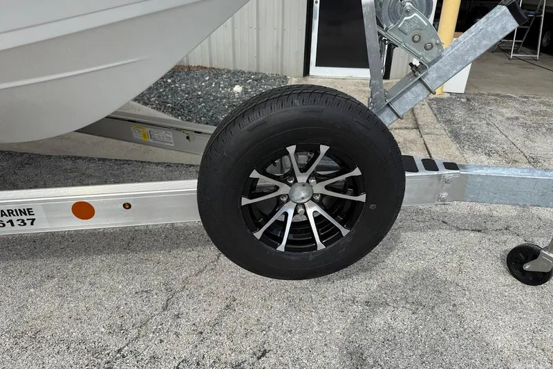 Slide: The Image of Trailer wheel of 2026 Sea Pro 230 Bay boat on concrete surface. - 3