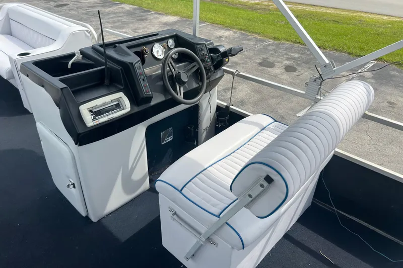 Slide: The Image of 1991 Spectrum 24 Cruise boat interior with steering console and white seating. - 11