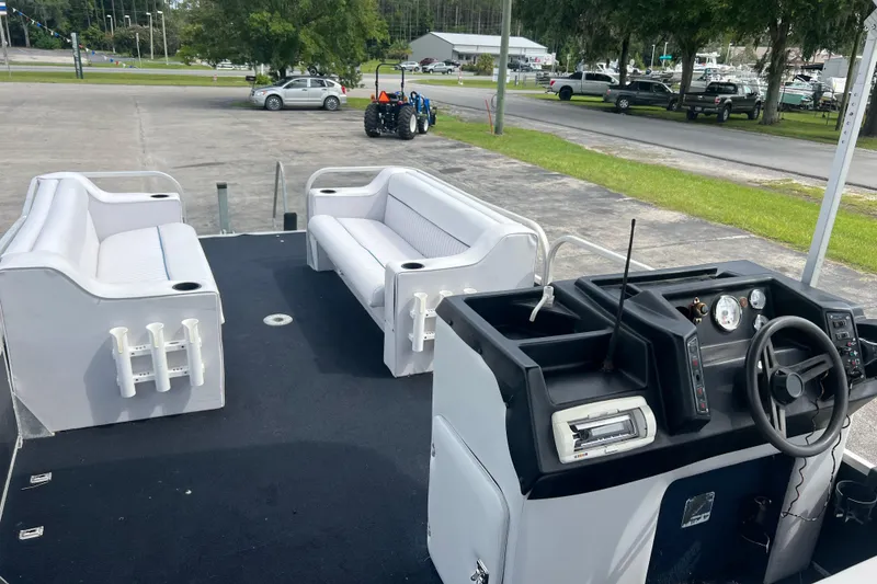 Slide: The Image of 1991 Spectrum 24 Cruise boat interior with seating and control panel, parked outdoors. - 13