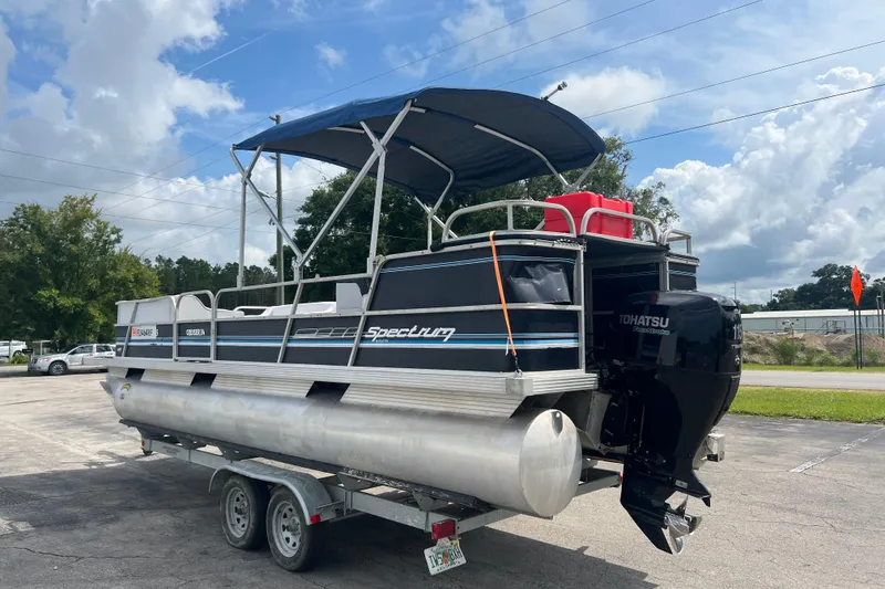 Slide: The Image of 1991 Spectrum 24 Cruise pontoon boat with Tohatsu outboard motor on trailer. - 6