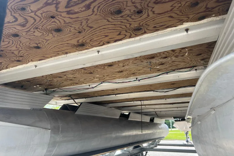 Slide: The Image of Underside view of a 1991 Spectrum 24 Cruise pontoon boat showing plywood and wiring. - 7