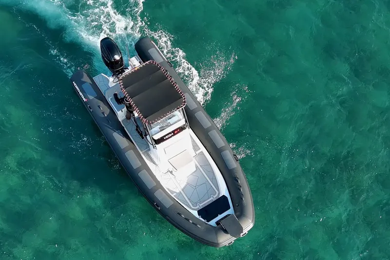 Slide: The Image of Aerial view of 2026 Northstar VEGA 6.4 boat cruising on turquoise water. - 1