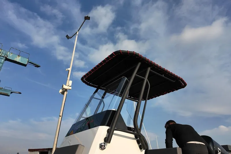 Slide: The Image of 2026 Northstar VEGA 6.4 boat with canopy under a clear blue sky. - 13