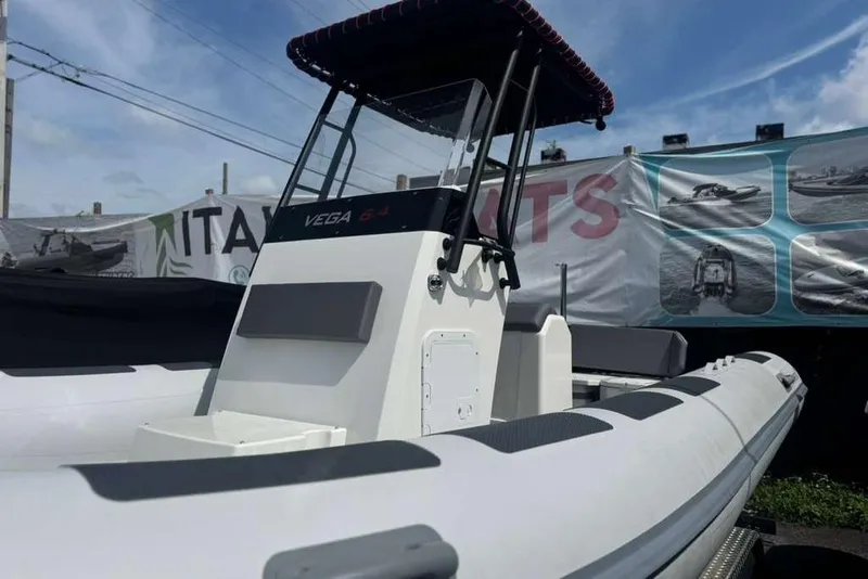 Slide: The Image of 2026 Northstar VEGA 6.4 boat cruising on open water, creating a wake. - 15