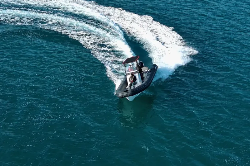 Slide: The Image of 2026 Northstar VEGA 6.4 boat with Suzuki engine, docked near a marina. - 20