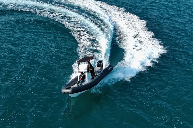 Slide: The Image of Northstar VEGA 6.4 boat making sharp turn on open water, 2026 model. - 4