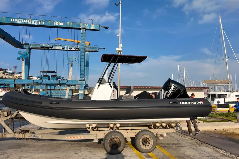 Slide: The Image of Northstar VEGA 6.4 boat on trailer at marina, 2026 model. - 9