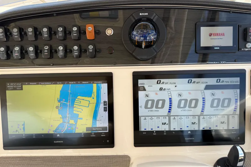 Slide: The Image of 2023 Grady-White Freedom 335 dashboard with Garmin navigation and Yamaha display. - 11