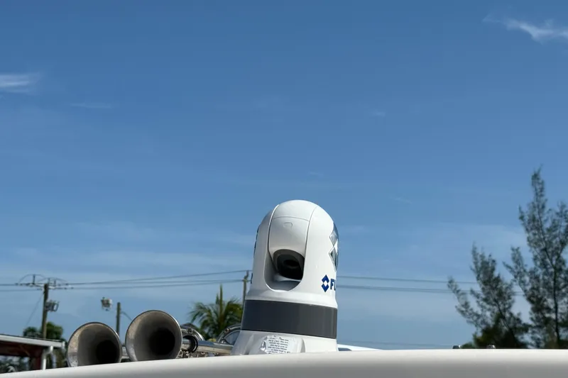 Slide: The Image of 2023 Grady-White Freedom 335 boat with radar equipment against a clear blue sky. - 14