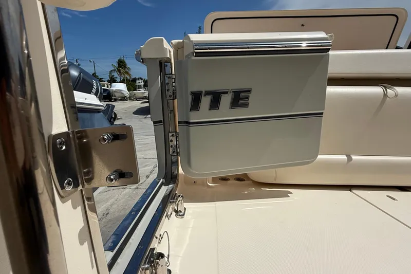 Slide: The Image of 2023 Grady-White Freedom 335 boat interior with open hatch and visible hardware. - 24