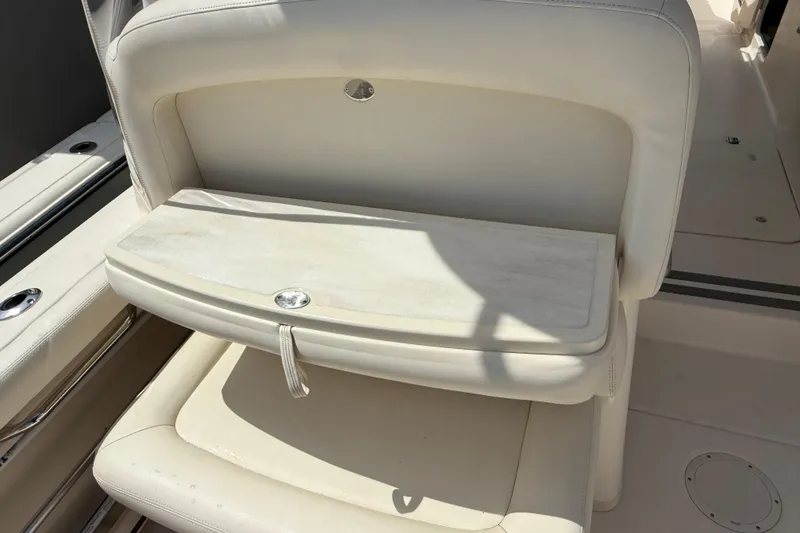 Slide: The Image of 2023 Grady-White Freedom 335 boat seat with foldable table in beige upholstery. - 25