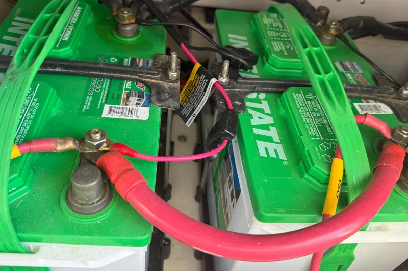Slide: The Image of Batteries in a 2023 Grady-White Freedom 335 boat, featuring green Interstate branding. - 29