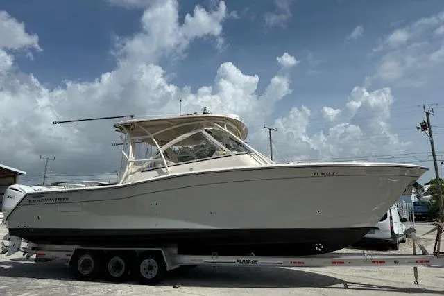 Slide: The Image of 2023 Grady-White Freedom 335 boat on trailer under cloudy sky. - 38