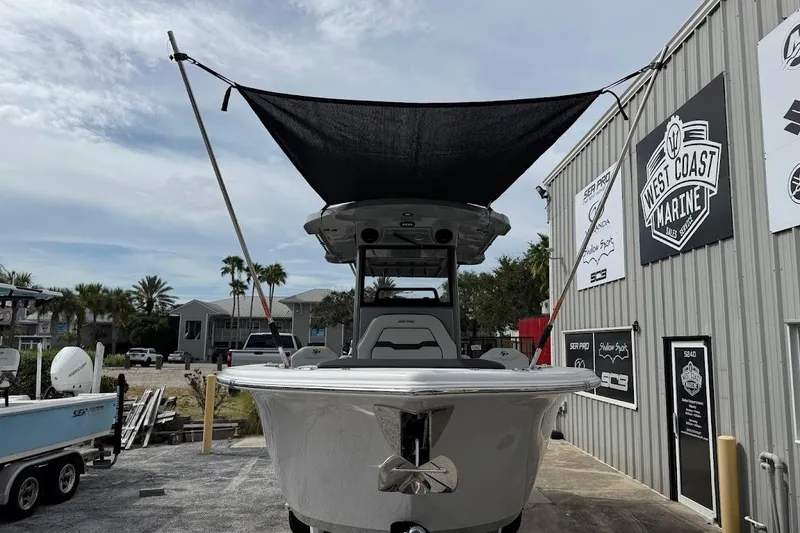 Slide: The Image of 2026 Sea Pro 245 Sandbar boat displayed at West Coast Marine dealership. - 11