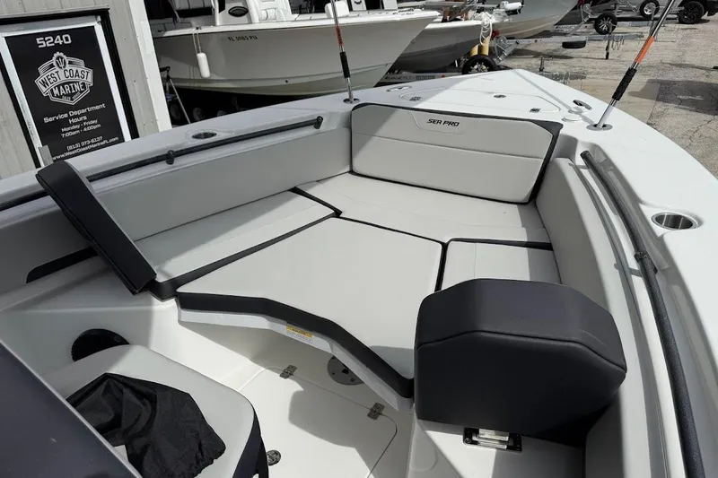 Slide: The Image of 2026 Sea Pro 245 Sandbar boat interior with cushioned seating and sleek design. - 13