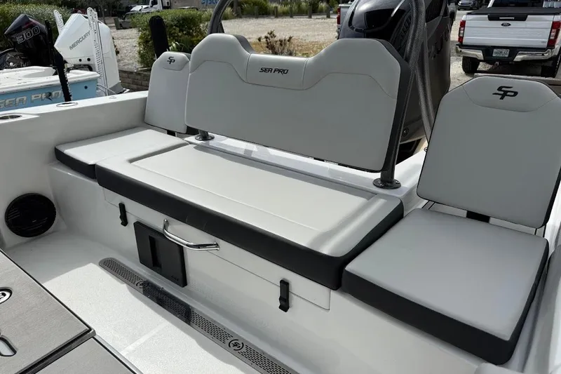 Slide: The Image of 2026 Sea Pro 245 Sandbar boat seating area with storage and sleek design. - 16