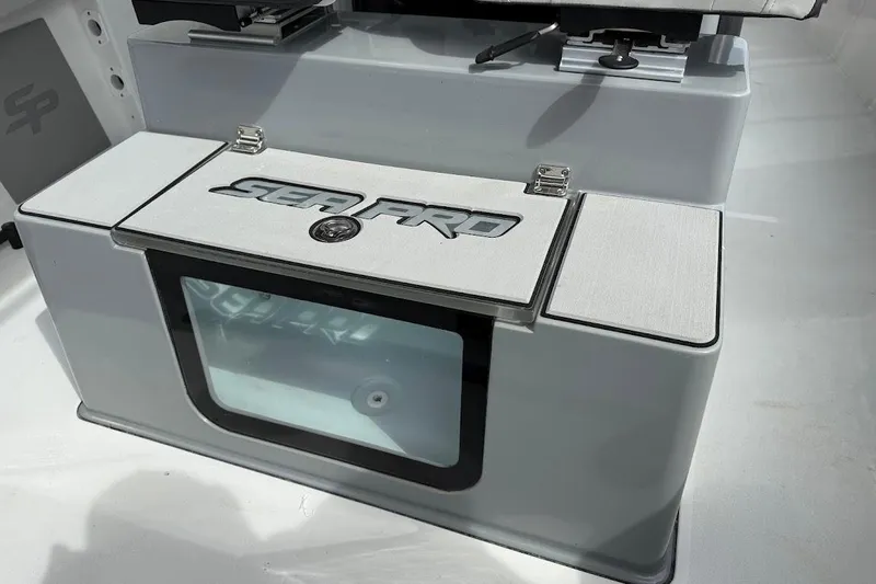 Slide: The Image of 2026 Sea Pro 245 Sandbar boat console with storage compartment and logo. - 18