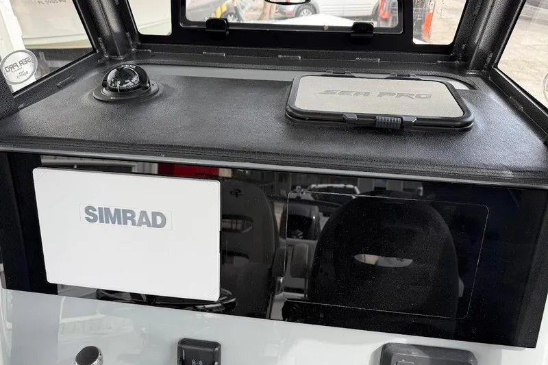Slide: The Image of 2026 Sea Pro 245 Sandbar dashboard with Simrad display and compass. - 22