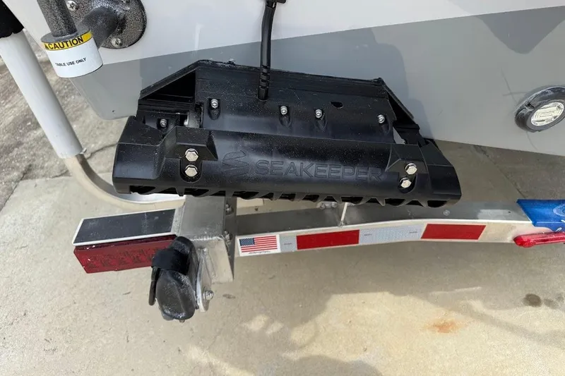 Slide: The Image of 2026 Sea Pro 245 Sandbar boat with Seakeeper stabilizer on trailer. - 5