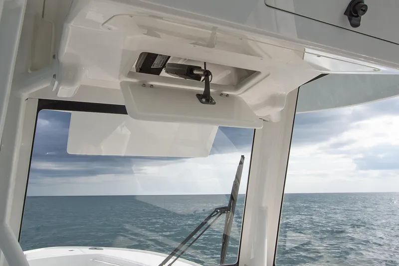 Slide: The Image of Luxury seating on 2026 Regulator 28 boat, featuring sleek white design in a modern showroom. - 12