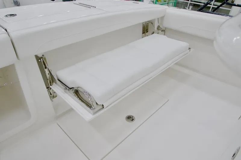 Slide: The Image of 2026 Regulator 28 boat with foldable white bench seat in cockpit area. - 17