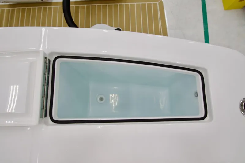 Slide: The Image of 2026 Regulator 28 boat livewell with open lid, showcasing interior design. - 19