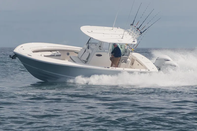 Slide: The Image of 2026 Regulator 28 boat in a manufacturing facility, showcasing sleek design and craftsmanship. - 2