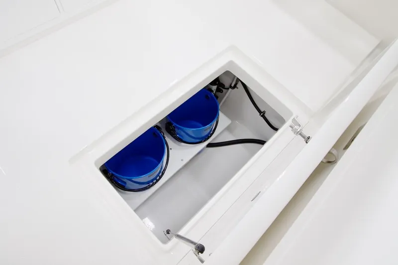 Slide: The Image of 2026 Regulator 28 boat storage compartment with blue containers inside. - 20