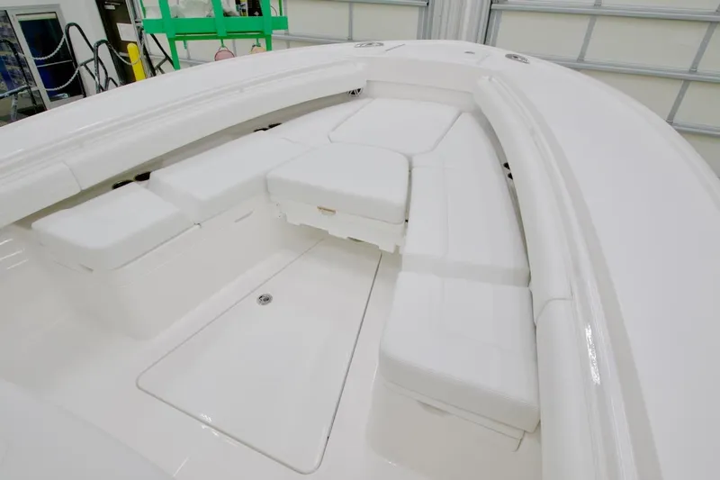 Slide: The Image of 2026 Regulator 28 boat interior with white cushioned seating in a spacious layout. - 21