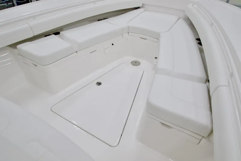 Slide: The Image of 2026 Regulator 28 boat interior with white cushioned seating and storage compartments. - 22