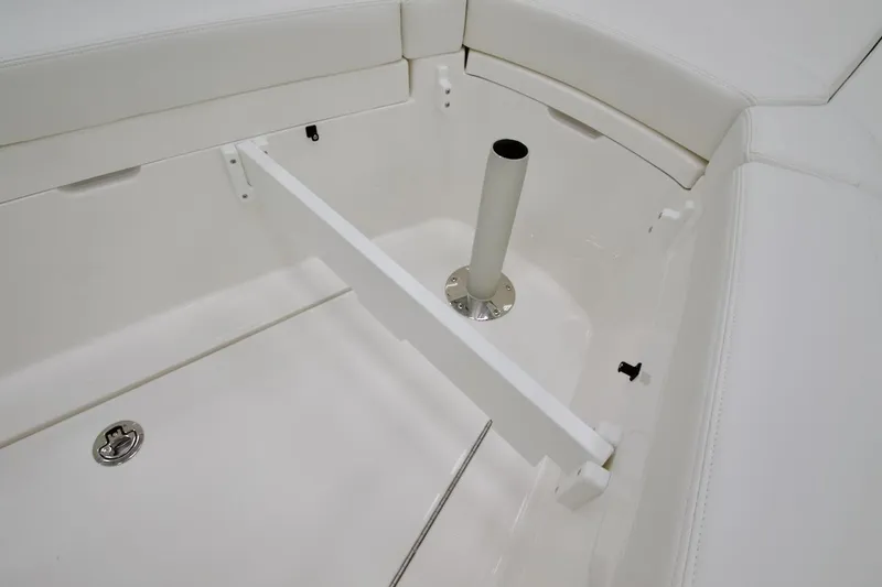 Slide: The Image of 2026 Regulator 28 boat interior seating area with white upholstery and storage compartment. - 24