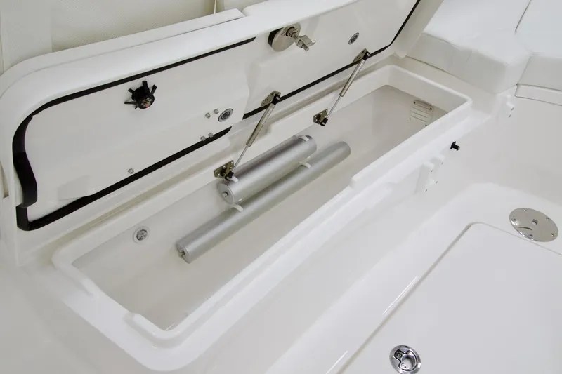 Slide: The Image of 2026 Regulator 28 boat storage compartment with hydraulic supports and sleek white finish. - 25