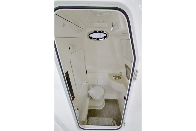 Slide: The Image of 2026 Regulator 28 boat interior with compact bathroom and modern amenities. - 28