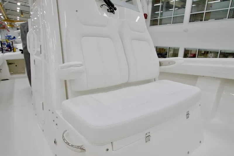 Slide: The Image of 2026 Regulator 28 boat interior with white cushioned seating in a showroom. - 30