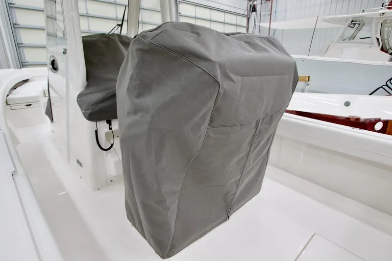 Slide: The Image of 2026 Regulator 28 boat with covered console in a storage facility. - 32