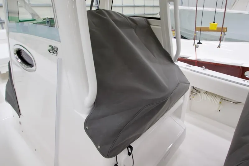 Slide: The Image of 2026 Regulator 28 boat interior with protective cover, showcasing sleek design and modern features. - 33