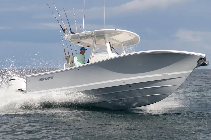 Slide: The Image of 2026 Regulator 28 boat cruising on open water with fishing rods. - 37