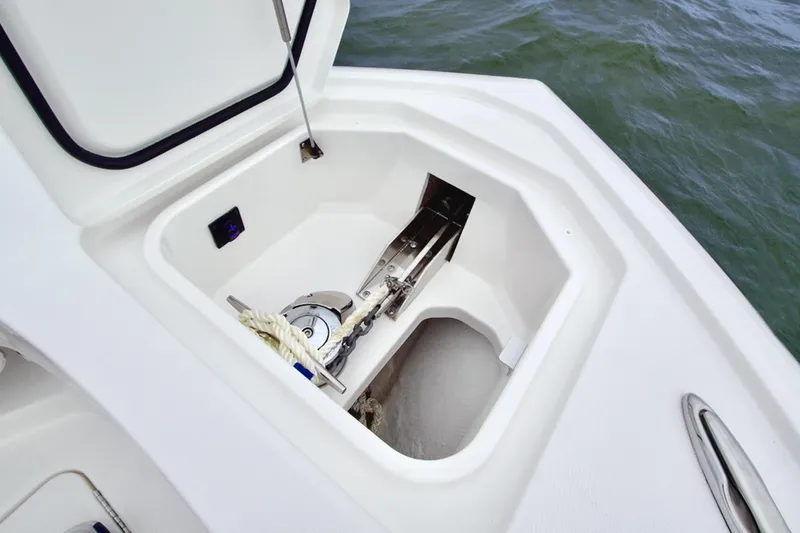 Slide: The Image of Anchor storage compartment on 2026 Regulator 28 boat, open lid, showing anchor and rope. - 38