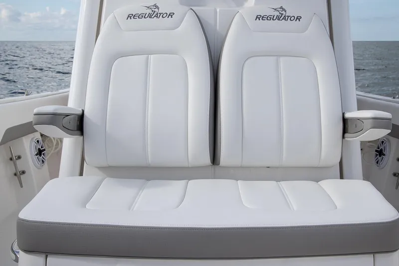 Slide: The Image of 2026 Regulator 28 boat seats with white upholstery and ocean backdrop. - 41