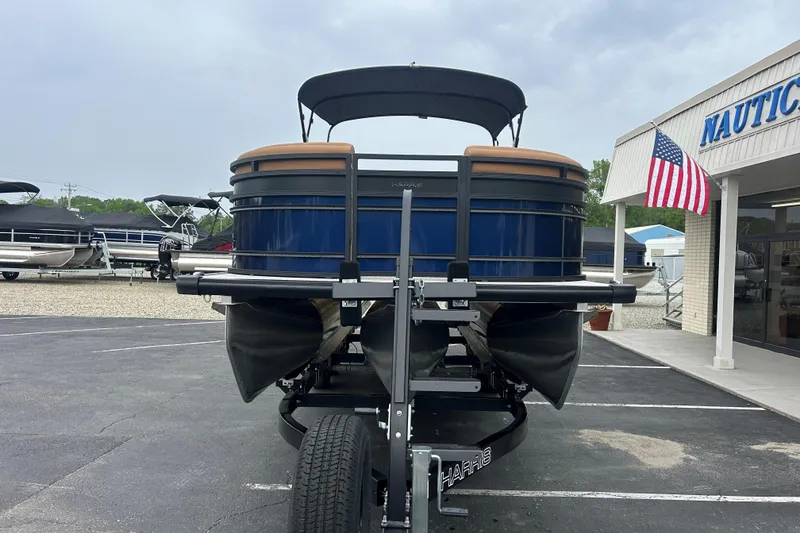 Slide: The Image of 2026 Harris FloteBote Solstice 250 SL pontoon boat on trailer at dealership. - 2