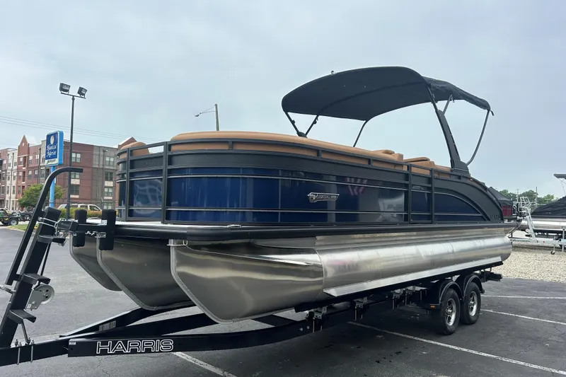 Slide: The Image of 2026 Harris FloteBote Solstice 250 SL pontoon boat on trailer, parked outdoors. - 3