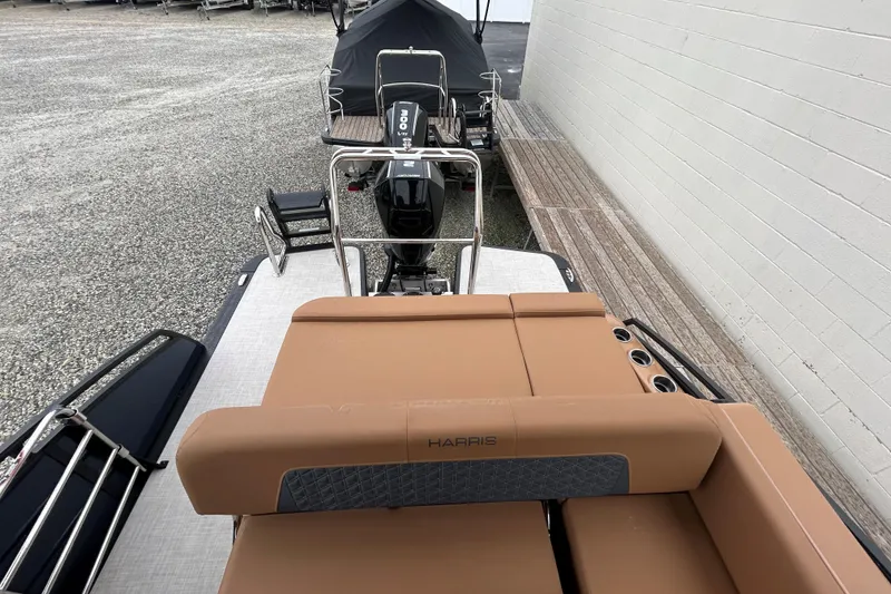 Slide: The Image of 2026 Harris FloteBote Solstice 250 SL pontoon boat with tan seating and powerful outboard motor. - 7