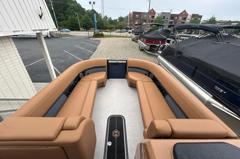 Slide: The Image of 2026 Harris FloteBote Solstice 250 SL pontoon boat with tan seating, docked outdoors. - 9