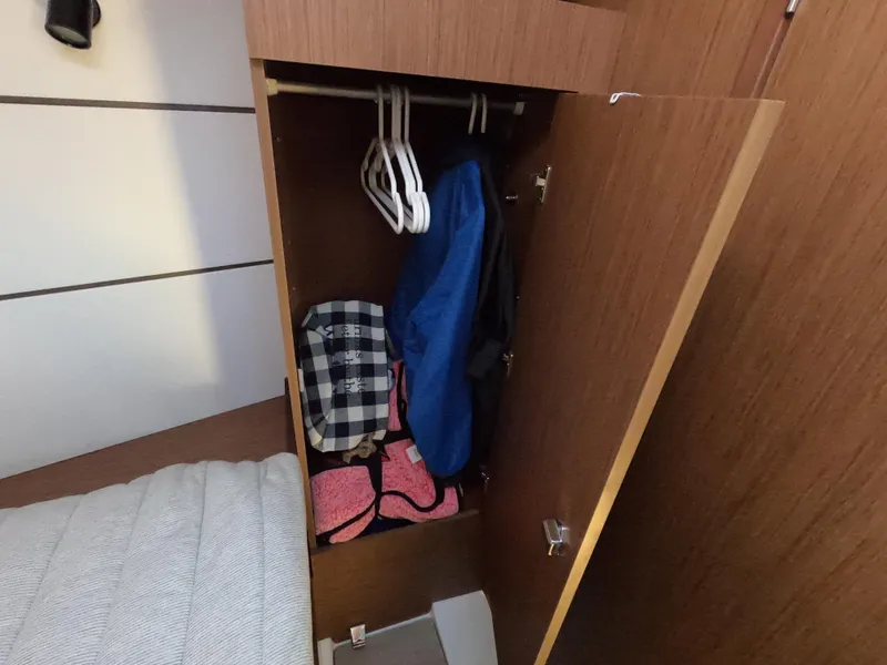 Slide: The Image of Closet interior on 2021 Beneteau Oceanis 38.1 yacht with clothes and hangers. - 14