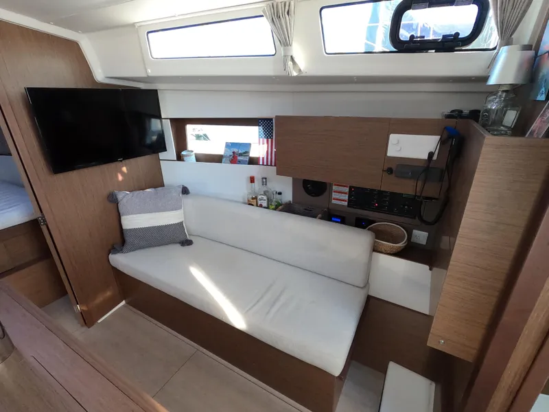 Slide: The Image of Modern interior of 2021 Beneteau Oceanis 38.1 yacht with cozy seating and entertainment area. - 18