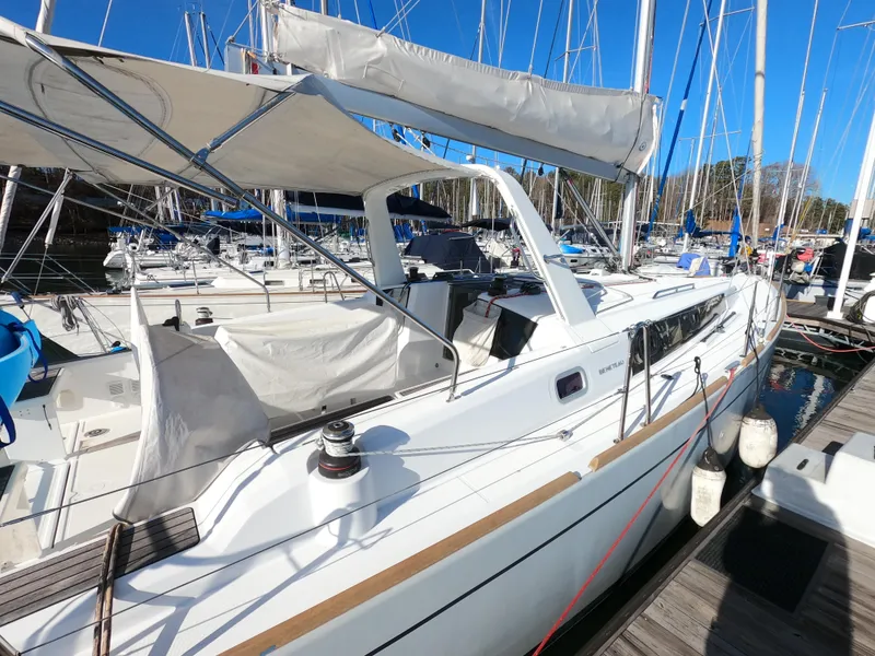 Slide: The Image of 2021 Beneteau Oceanis 38.1 sailboat docked in marina, featuring sleek design and modern amenities. - 2