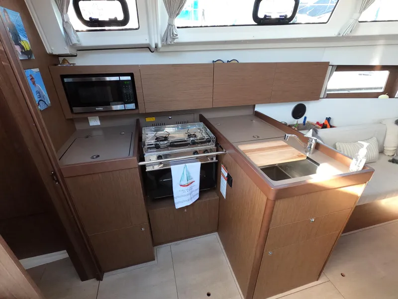Slide: The Image of Modern kitchen in 2021 Beneteau Oceanis 38.1 yacht with stove, sink, and microwave. - 20