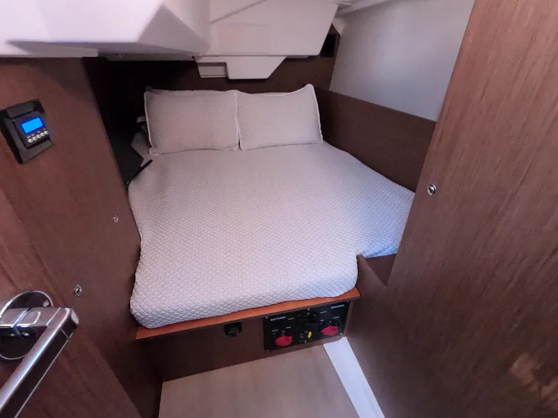 Slide: The Image of Cozy cabin interior of 2021 Beneteau Oceanis 38.1 sailboat with comfortable bedding. - 21