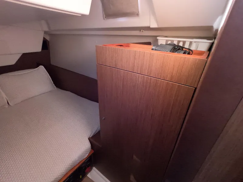 Slide: The Image of Cozy cabin interior of 2021 Beneteau Oceanis 38.1 with wooden cabinetry and bed. - 23